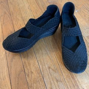 Elastic black woven wedge Mary Janes.